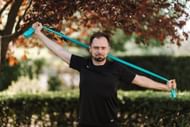 The chin tuck exercise can be done using a resistance band. (Photo via Pexels/Karolina Grabowska)